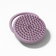 Noody silicone cradle cap brush in purple — food-grade silicone, soft nubs to lift scalp flakes without scratching baby's skin.